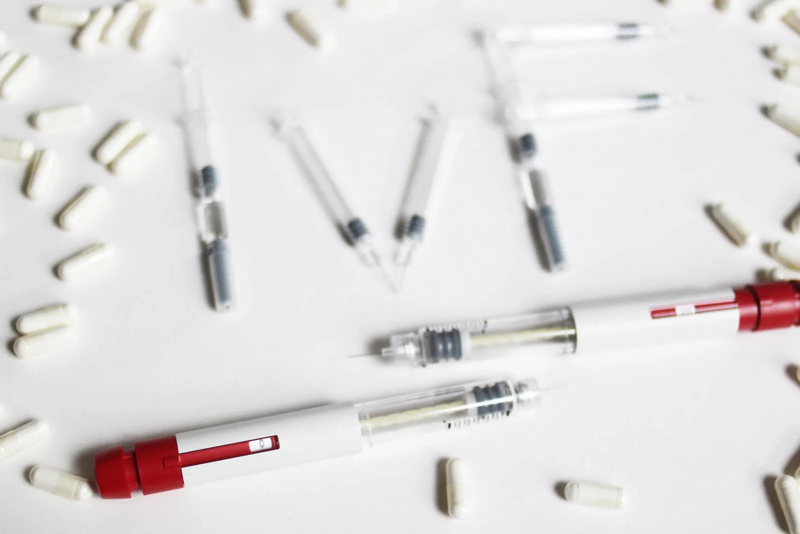 Fertility needles and medication laid out to spell IVF