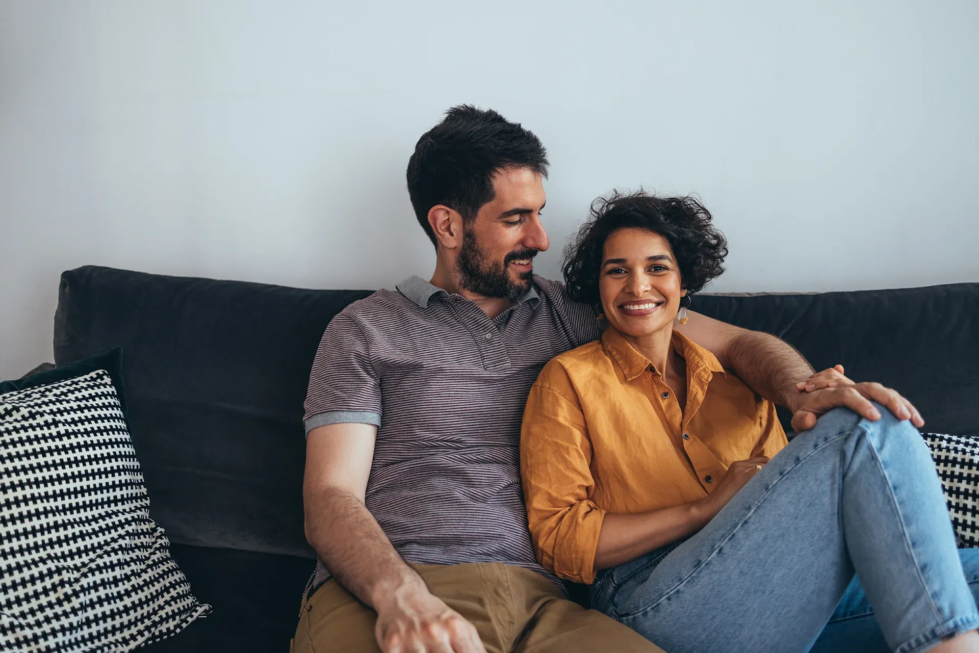 Two people embracing warmly in a cozy living room