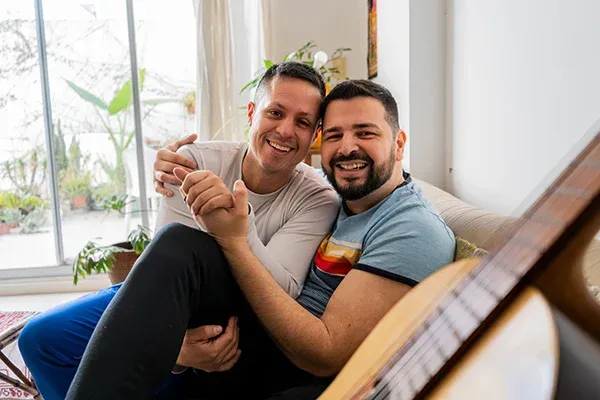 Two people embracing warmly in a cozy living room