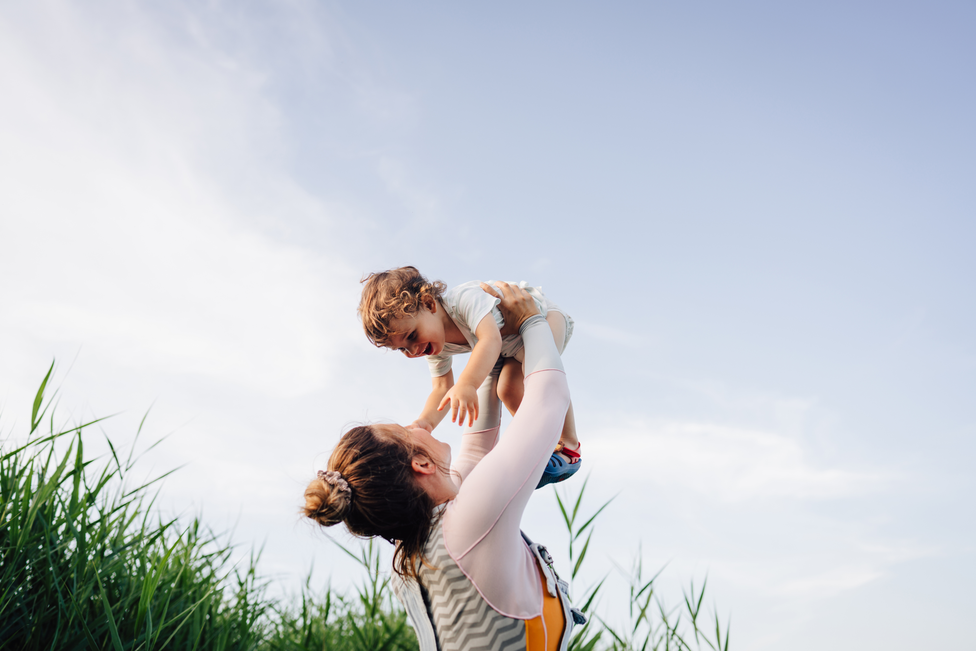 A gestational carrier lifting a baby